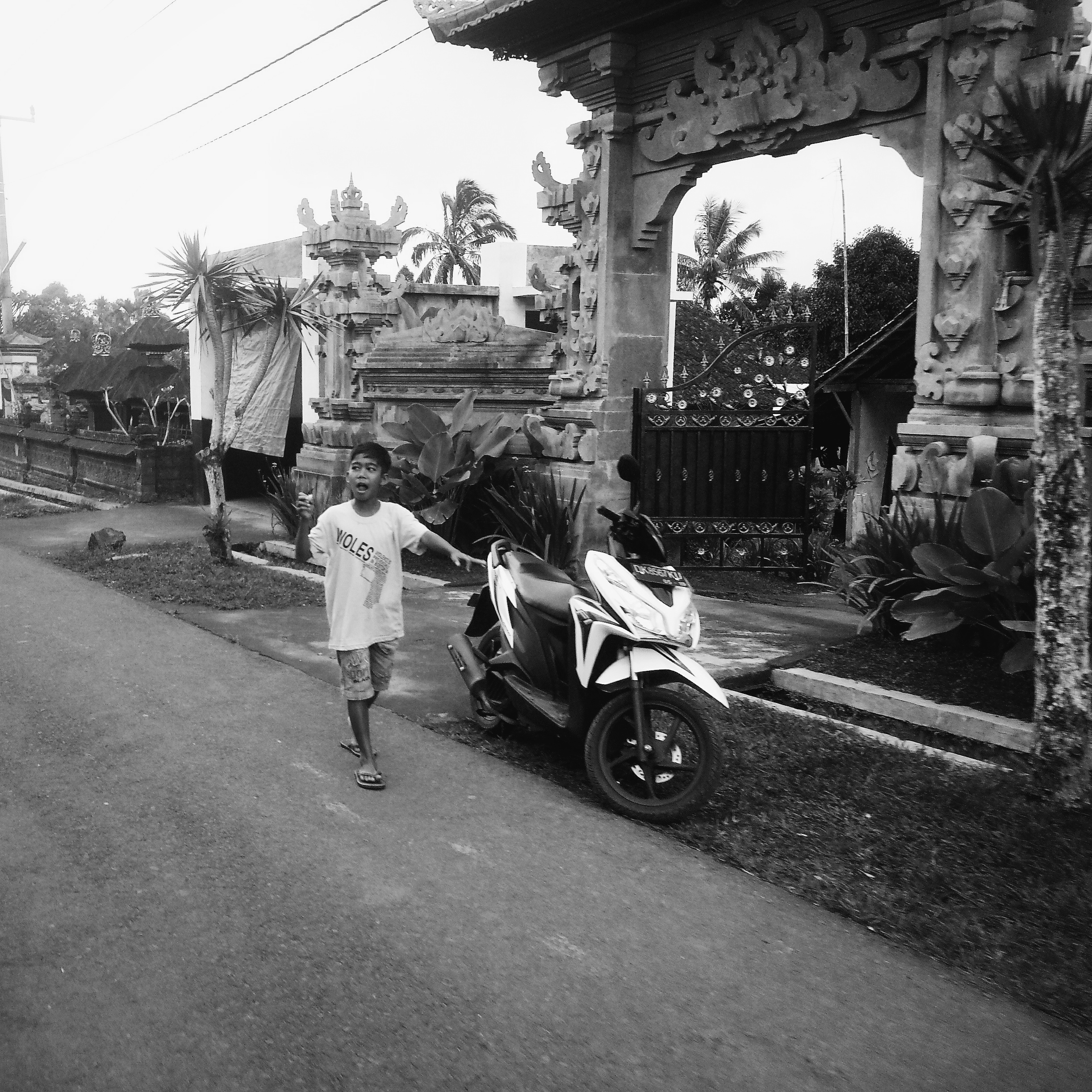This child happens to be taking a walk outside his home